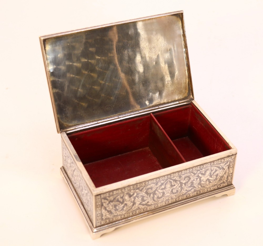 A rectangular sterling silver box featuring intricate black niello inlay artwork depicting a Thai temple architectural landscape on the lid and mythological figures along the sides. View VIII