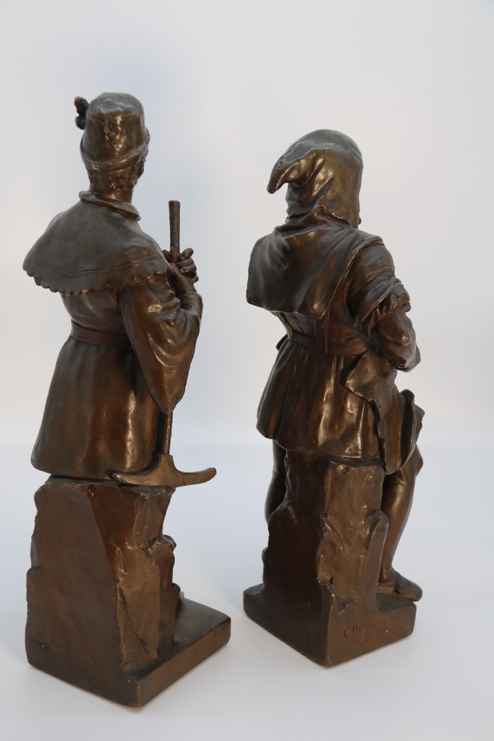 A pair of patinated electrotype bronze figures depicting historic tradesmen standing on rectangular plinths. View III