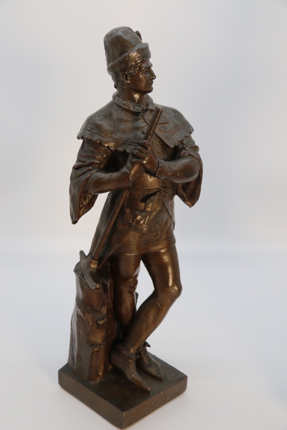 A pair of patinated electrotype bronze figures depicting historic tradesmen standing on rectangular plinths. View IX
