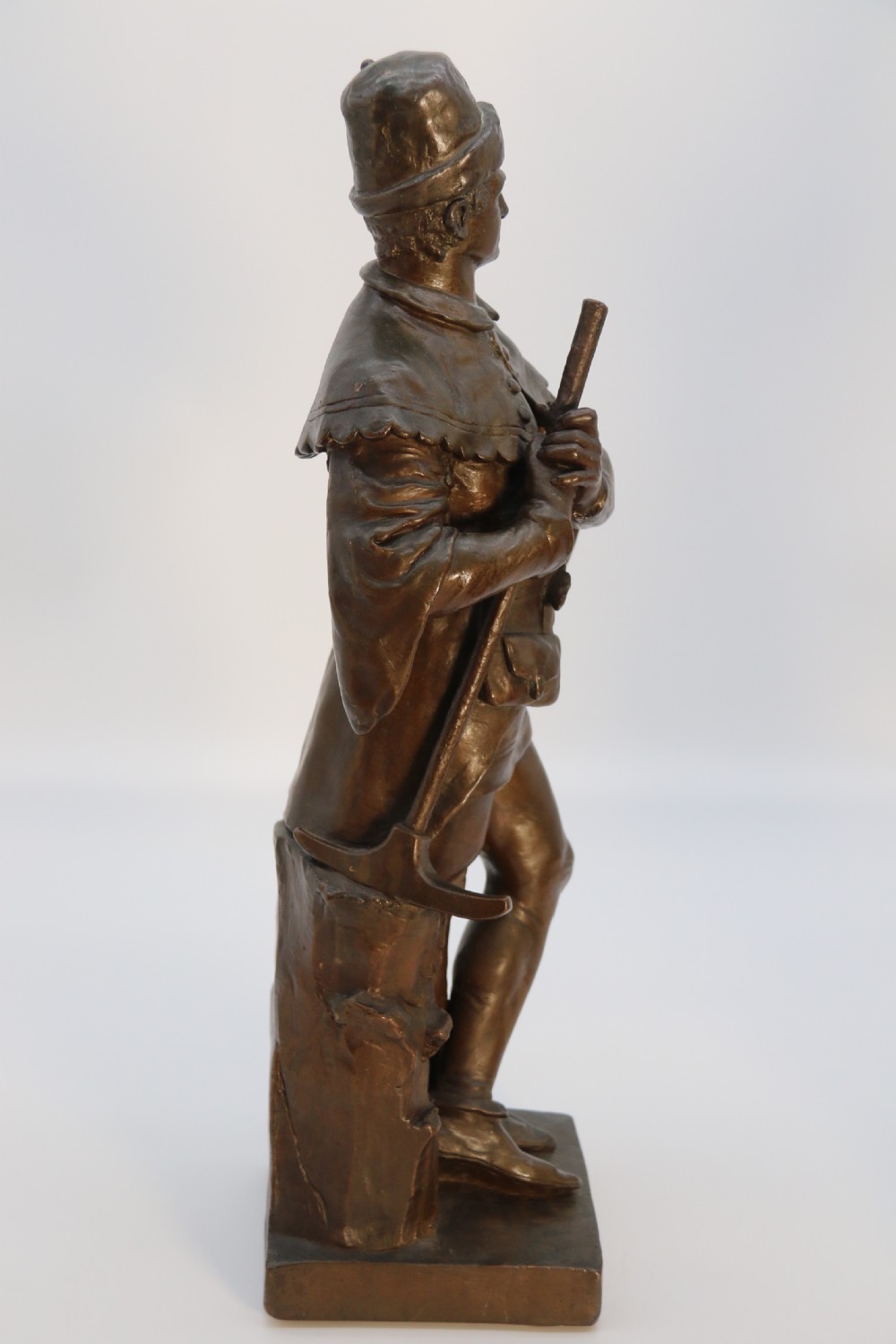 A pair of patinated electrotype bronze figures depicting historic tradesmen standing on rectangular plinths. View X