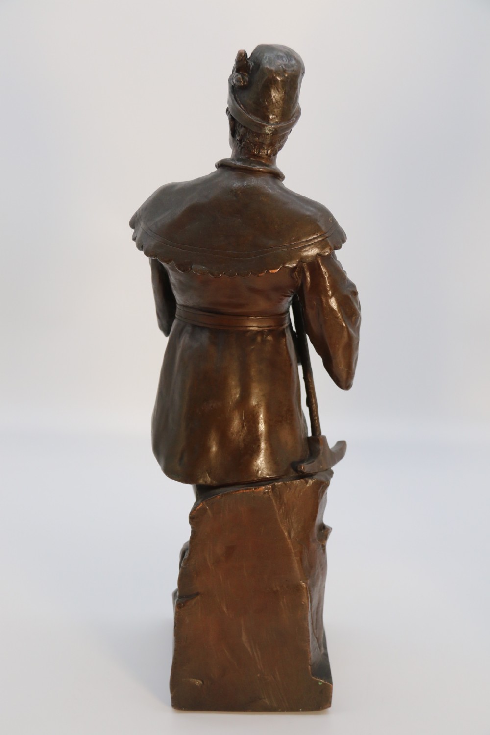 A pair of patinated electrotype bronze figures depicting historic tradesmen standing on rectangular plinths. View XII