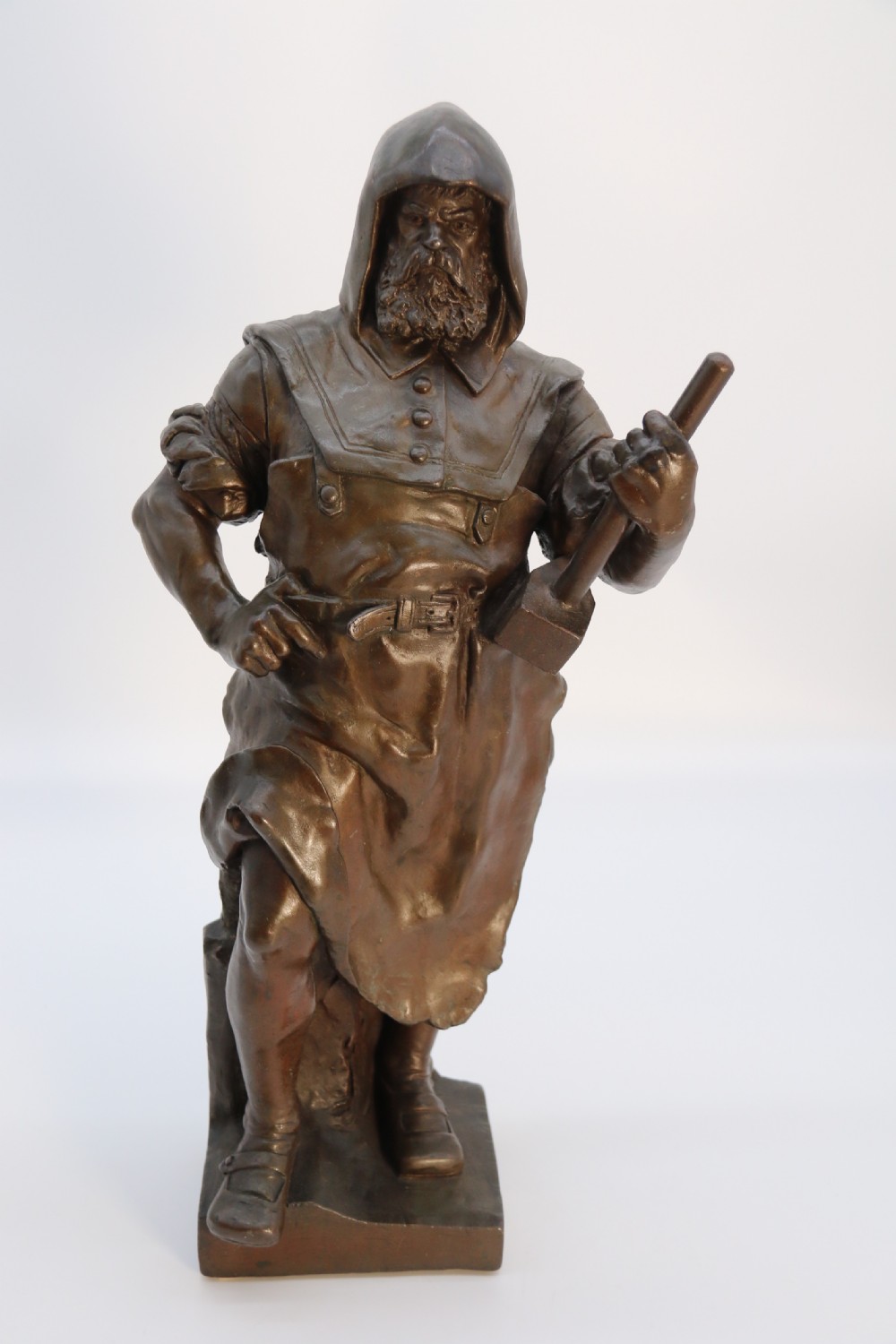 A pair of patinated electrotype bronze figures depicting historic tradesmen standing on rectangular plinths. View XXIII