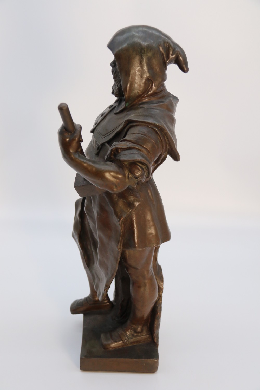 A pair of patinated electrotype bronze figures depicting historic tradesmen standing on rectangular plinths. View XXIX