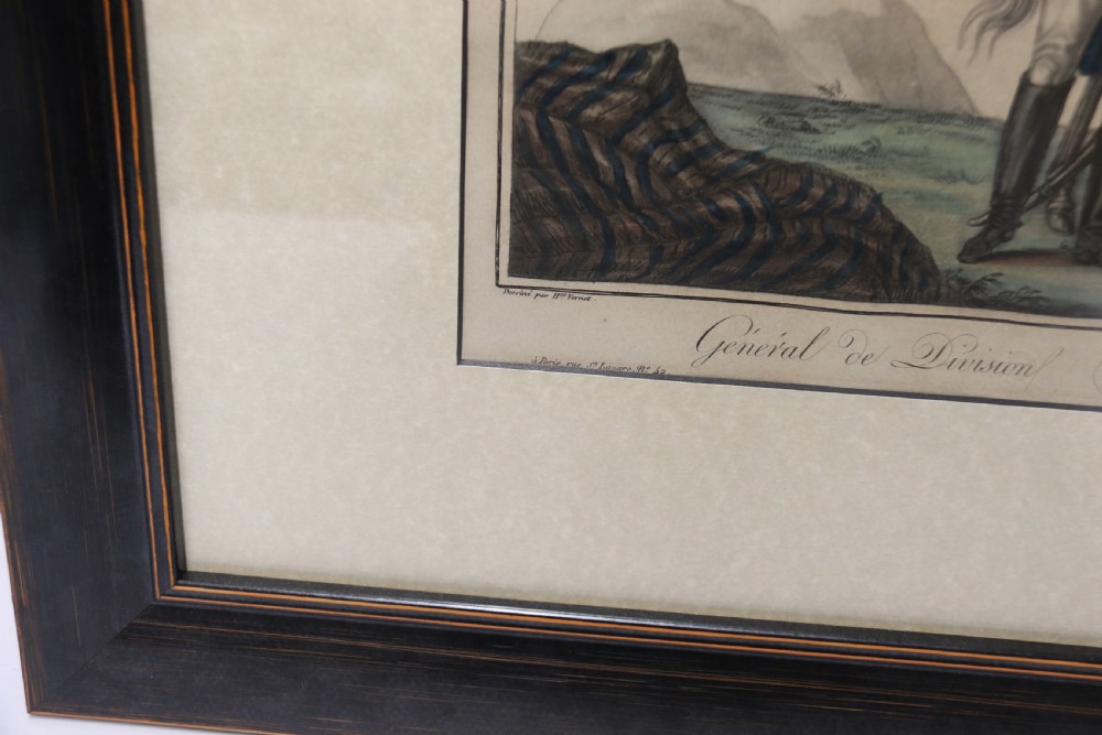 A framed early nineteenth-century hand-coloured print depicting a French Napoleonic military officer standing beside a grey horse in a landscape. View IV