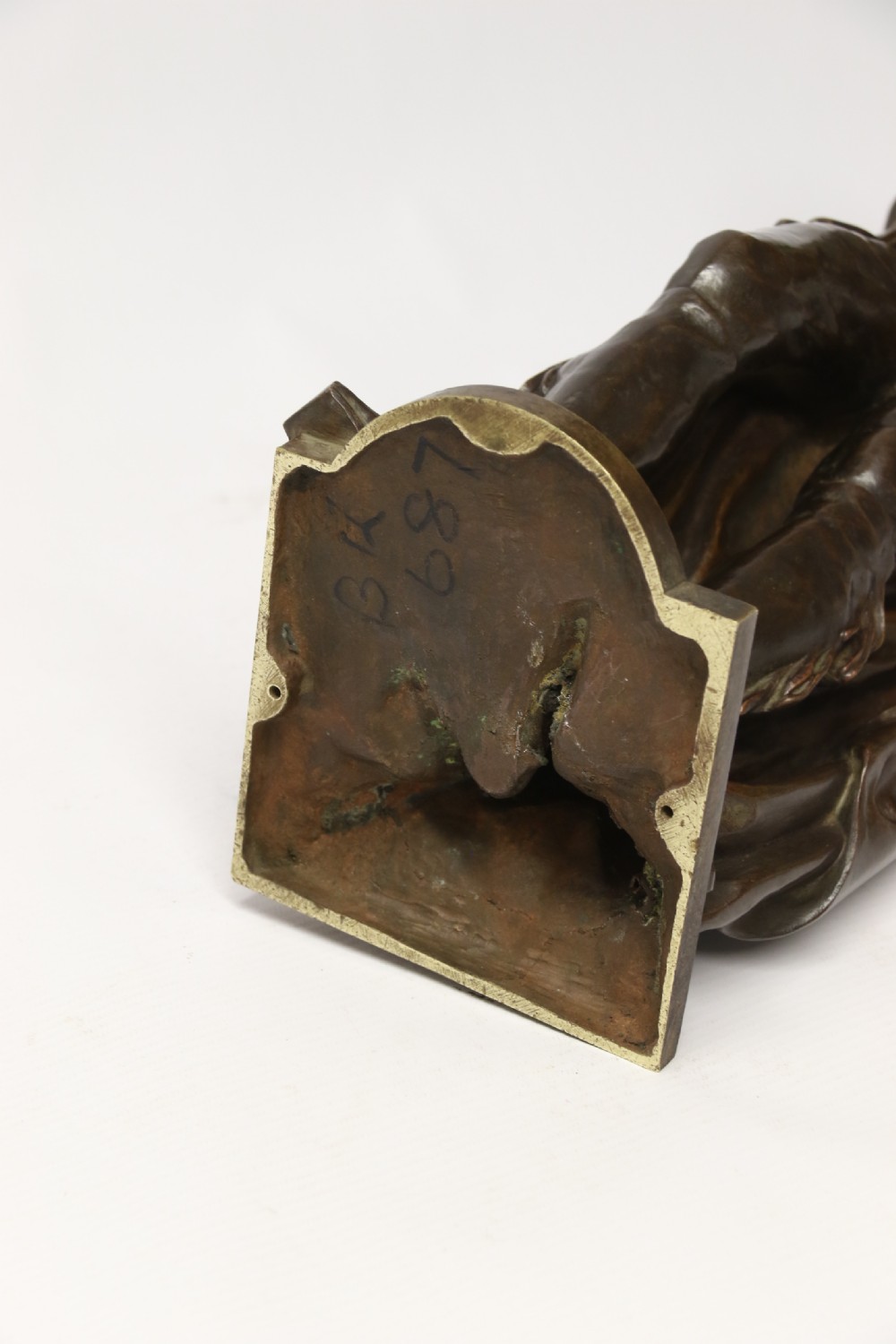 A patinated dark brown bronze sculpture depicting a standing male musician playing a mandolin while wearing a draped coat and headwear. View XX