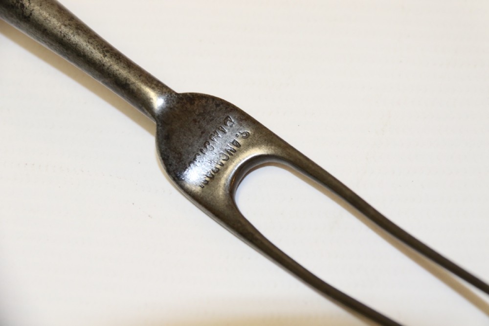 An early nineteenth-century roasting fork featuring a long, spiral horn handle with engraved silver mounts and a two-pronged steel tip. View XIII