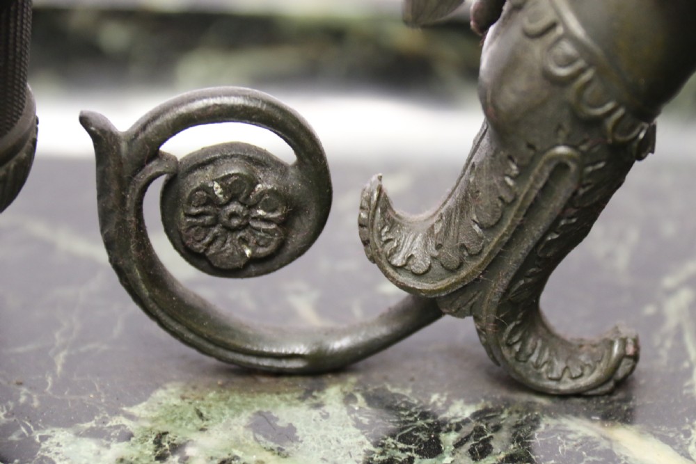 An Empire period dark green marble inkstand featuring dark patinated bronze cherub figures, twin urn inkwells, and carved claw feet. View XII