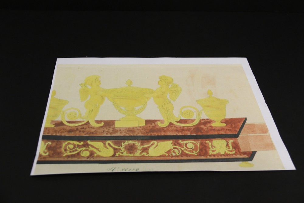 An Empire period dark green marble inkstand featuring dark patinated bronze cherub figures, twin urn inkwells, and carved claw feet. View XVIII