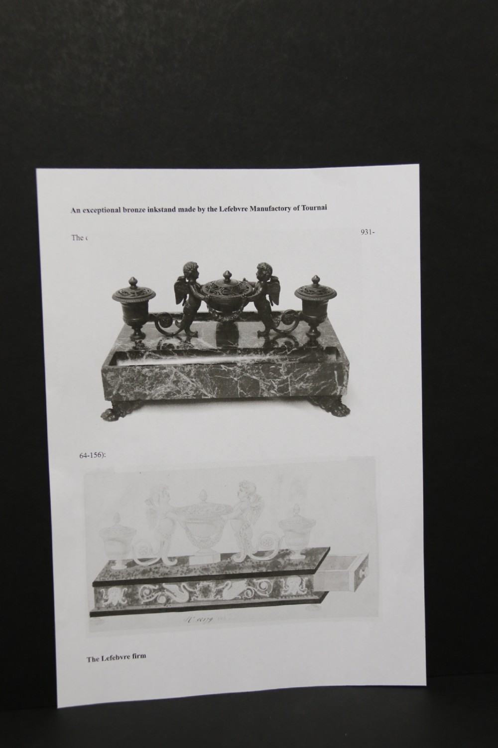 An Empire period dark green marble inkstand featuring dark patinated bronze cherub figures, twin urn inkwells, and carved claw feet. View XXI