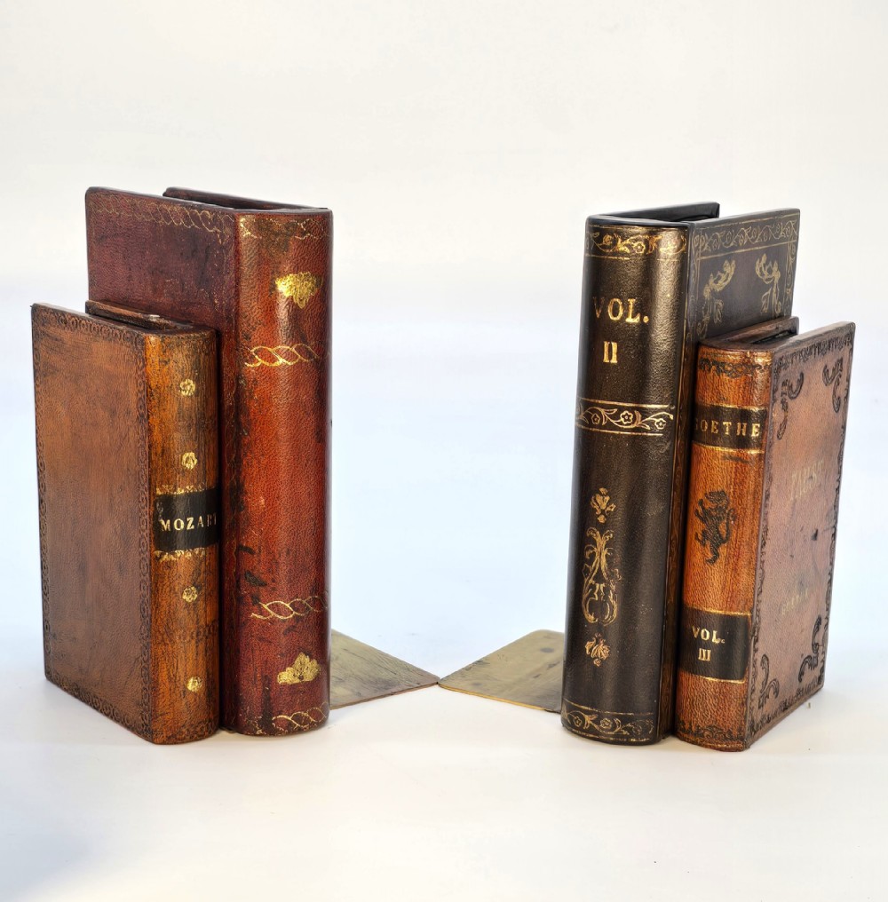 A pair of Bookends made in the form of antique leather bound books.