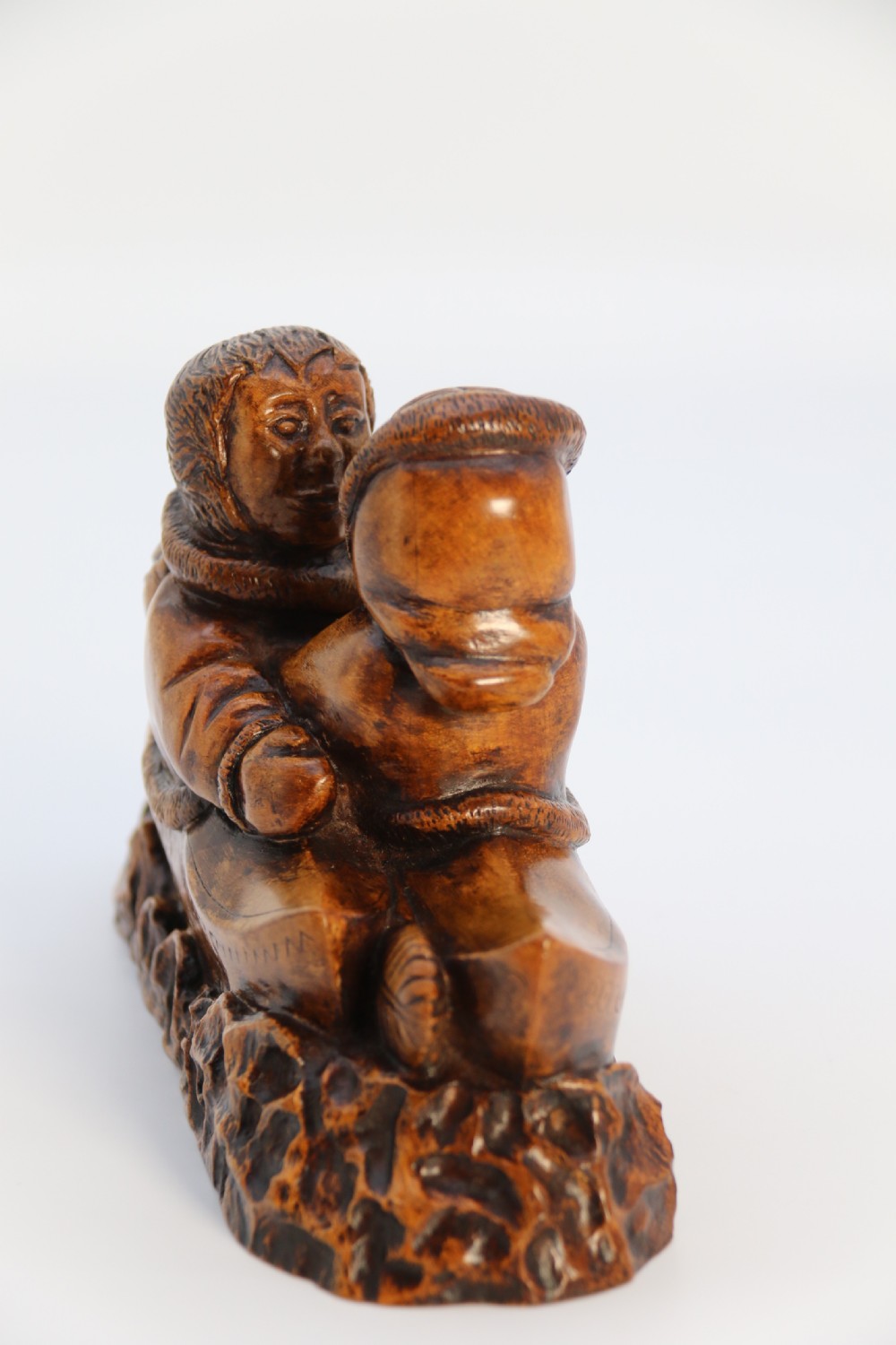 A rare early 20th century Canadian folk art maple wood carved Inuit figure group View V