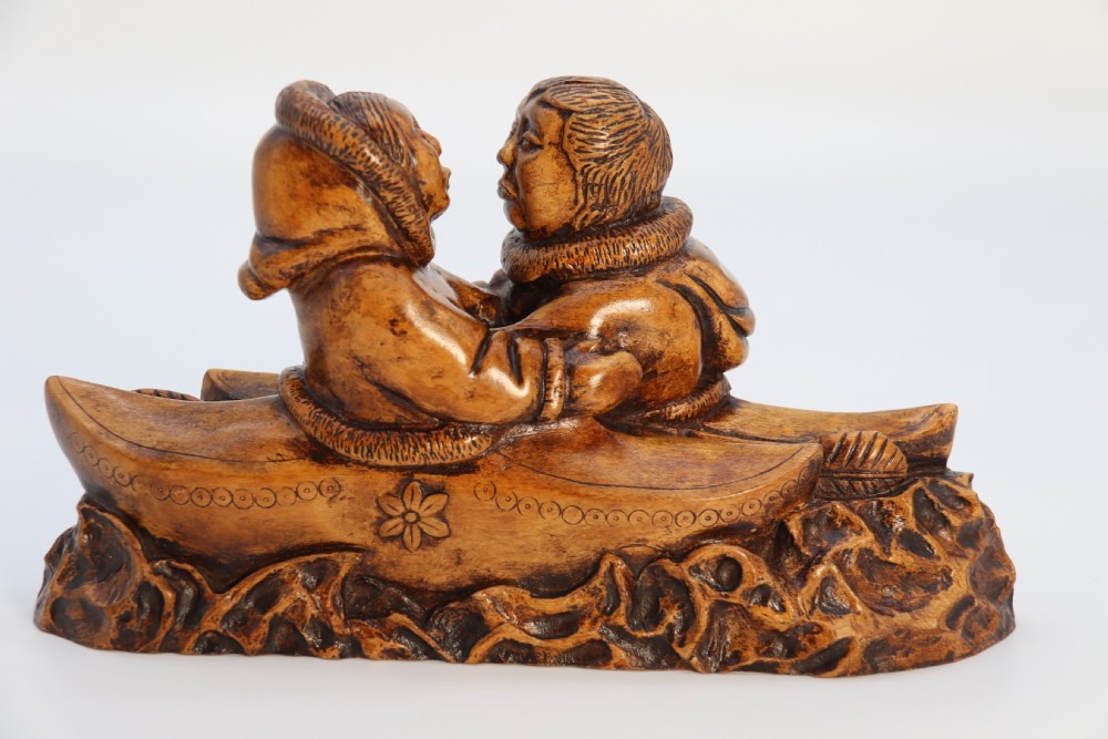 A rare early 20th century Canadian folk art maple wood carved Inuit figure group