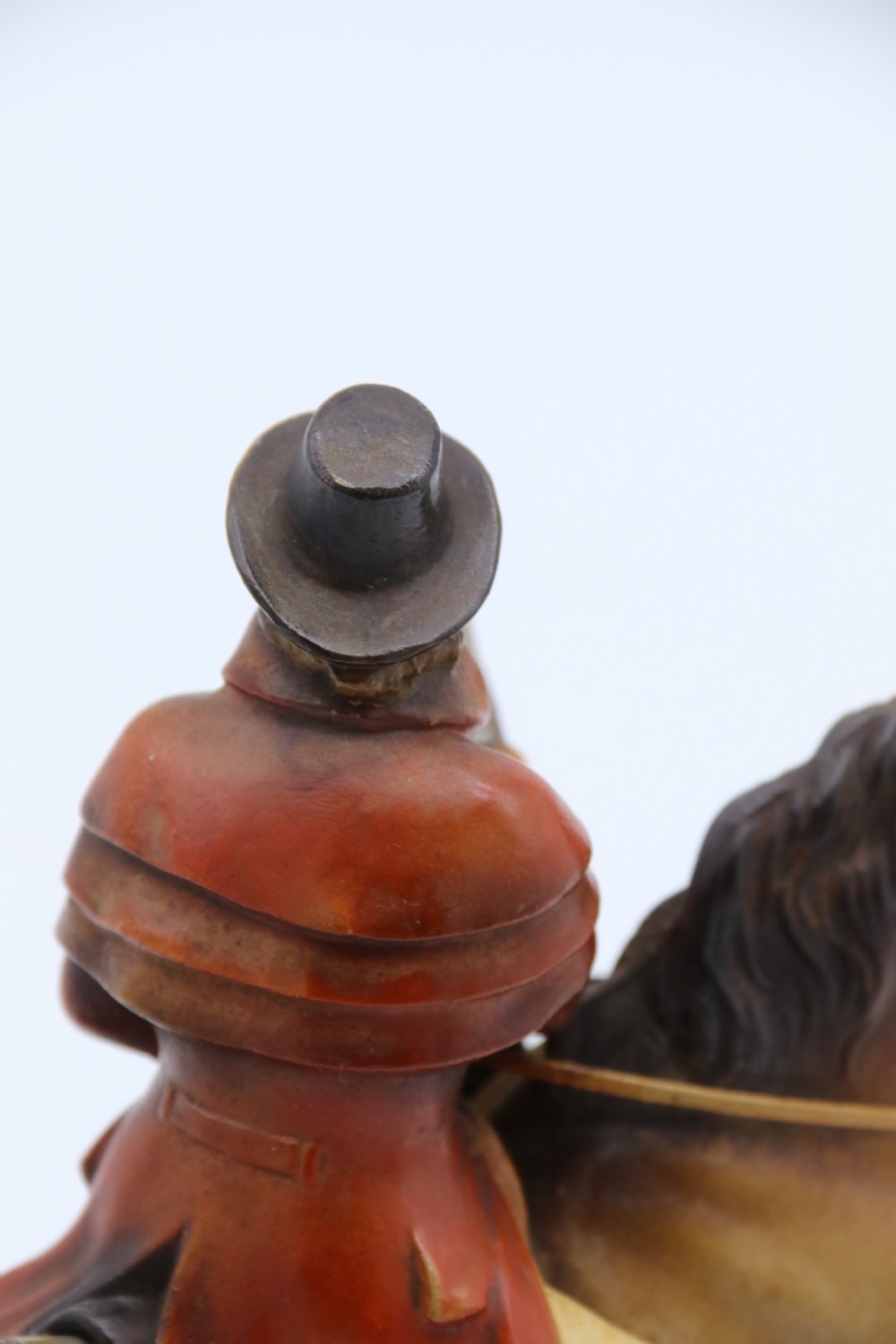 An Art Deco cold-painted metal figure of a masked highwayman on horseback mounted on a rectangular wooden plinth, featuring an integrated table lighter mechanism. View XIII