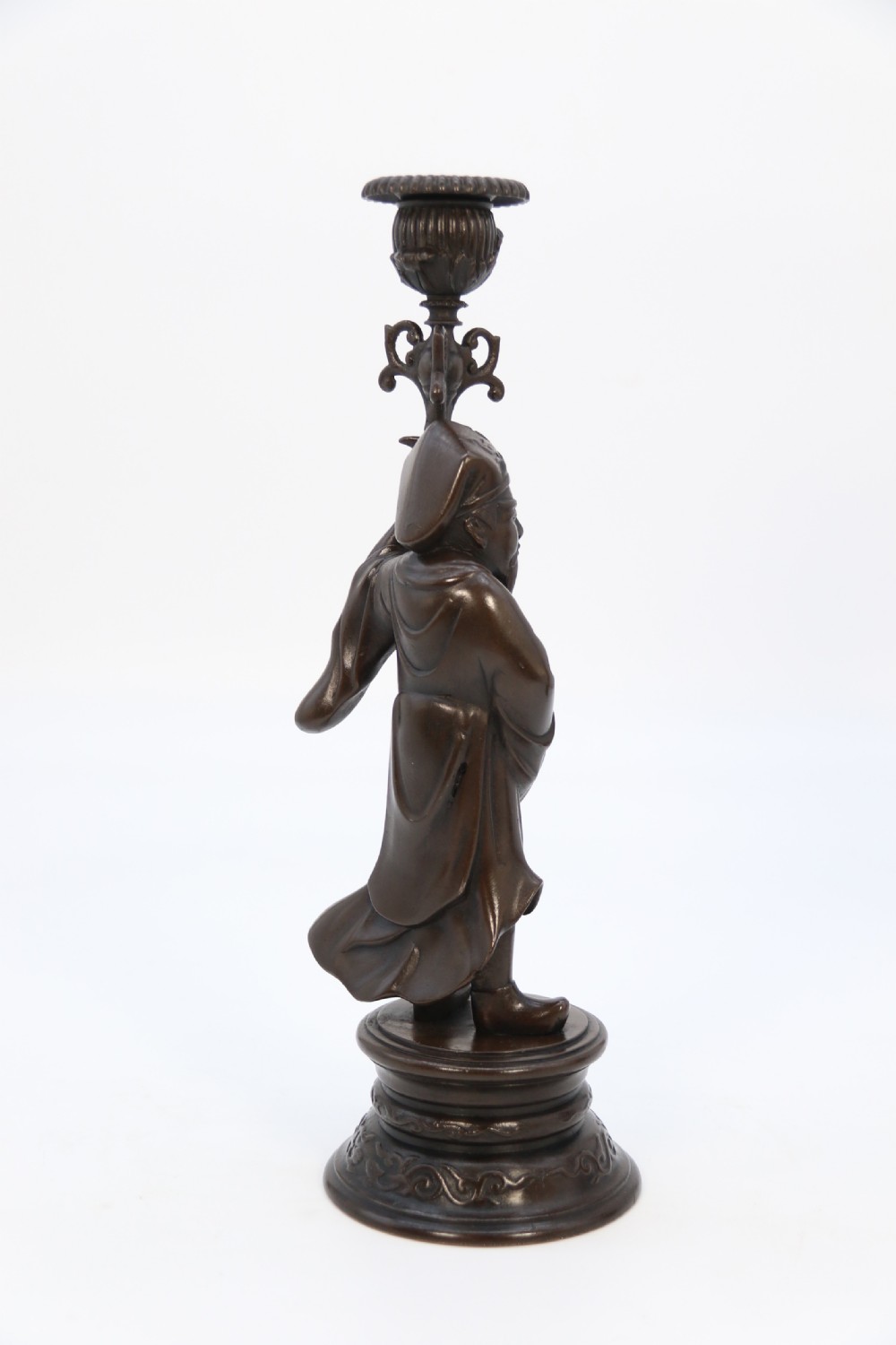 A pair of 19th-century French dark bronze candlesticks sculpted as standing Chinese figures holding flower-shaped candle nozzles on stepped round bases. View III