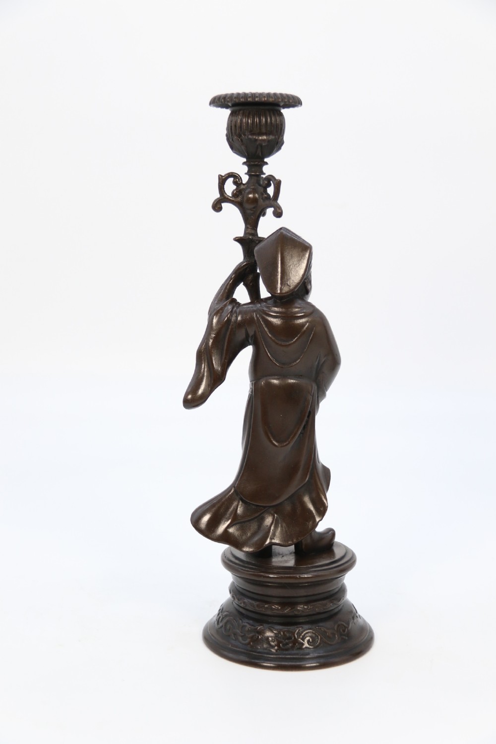 A pair of 19th-century French dark bronze candlesticks sculpted as standing Chinese figures holding flower-shaped candle nozzles on stepped round bases. View IV