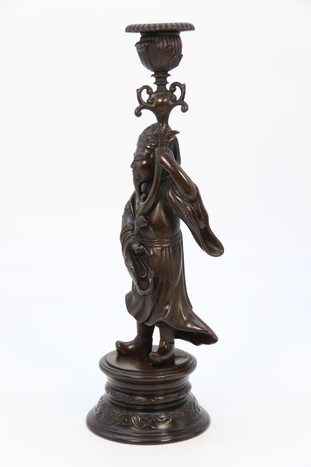 A pair of 19th-century French dark bronze candlesticks sculpted as standing Chinese figures holding flower-shaped candle nozzles on stepped round bases. View V