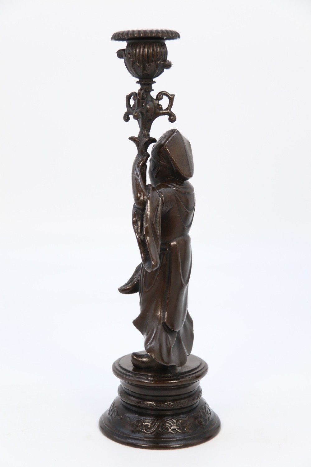 A pair of 19th-century French dark bronze candlesticks sculpted as standing Chinese figures holding flower-shaped candle nozzles on stepped round bases. View VI