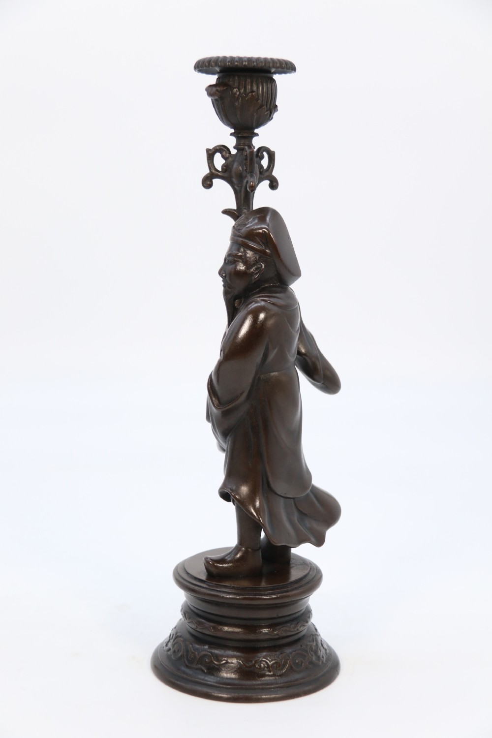A pair of 19th-century French dark bronze candlesticks sculpted as standing Chinese figures holding flower-shaped candle nozzles on stepped round bases. View XIII