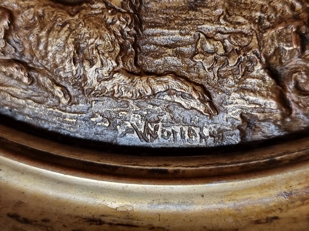 An Aesthetic Movement circular gilt metal tazza on a pedestal foot featuring ornate foliate scrollwork and a central relief medallion. View V