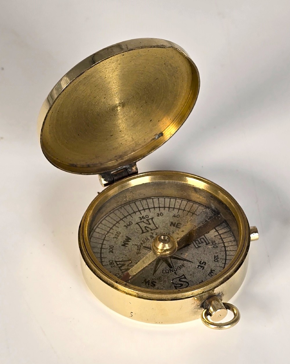 A fine brass pocket compass by Barker and Sons of London