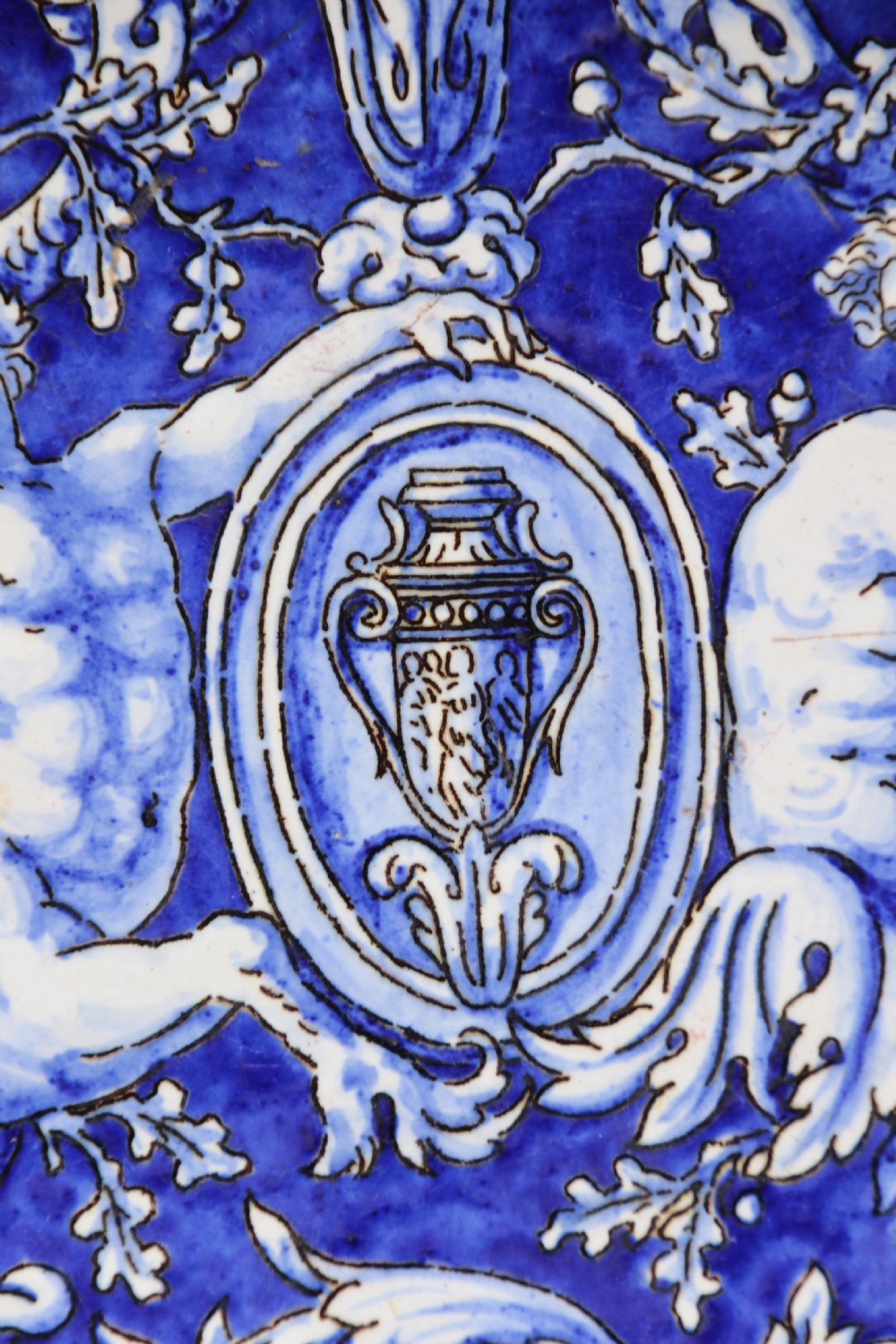 A hand-painted French Gien faience earthenware centrepiece dish with twin handles, decorated in cobalt blue and yellow mythological figures and acanthus scrollwork. View IV