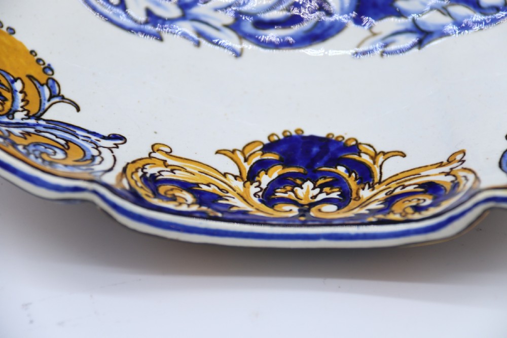 A hand-painted French Gien faience earthenware centrepiece dish with twin handles, decorated in cobalt blue and yellow mythological figures and acanthus scrollwork. View V