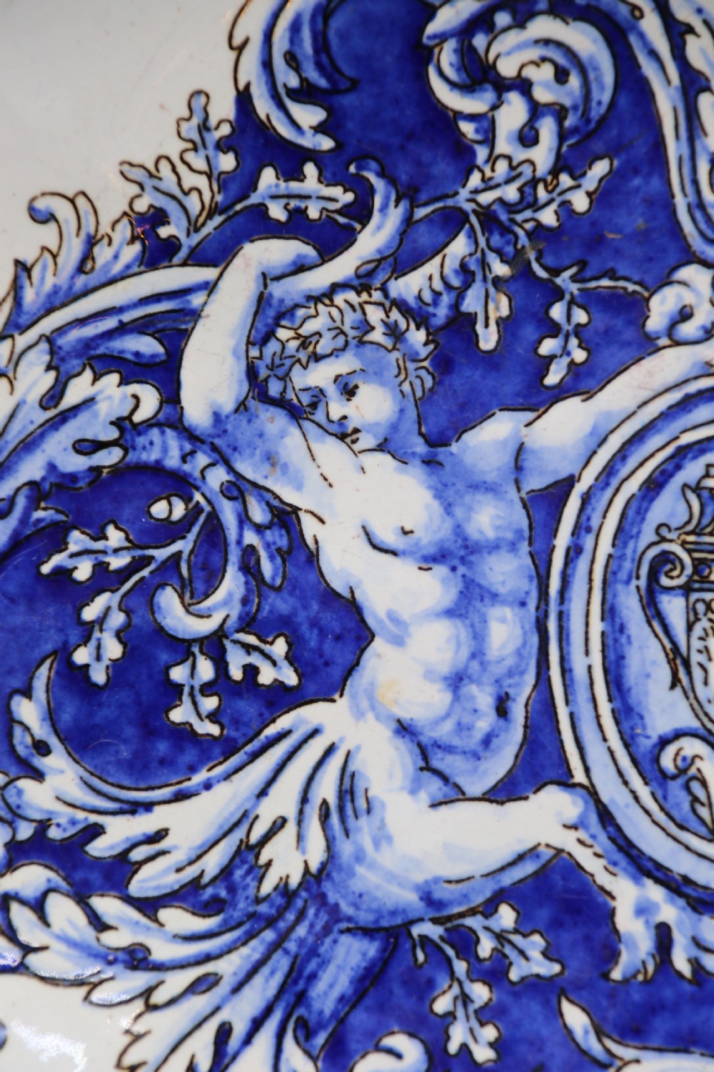 A hand-painted French Gien faience earthenware centrepiece dish with twin handles, decorated in cobalt blue and yellow mythological figures and acanthus scrollwork. View VI