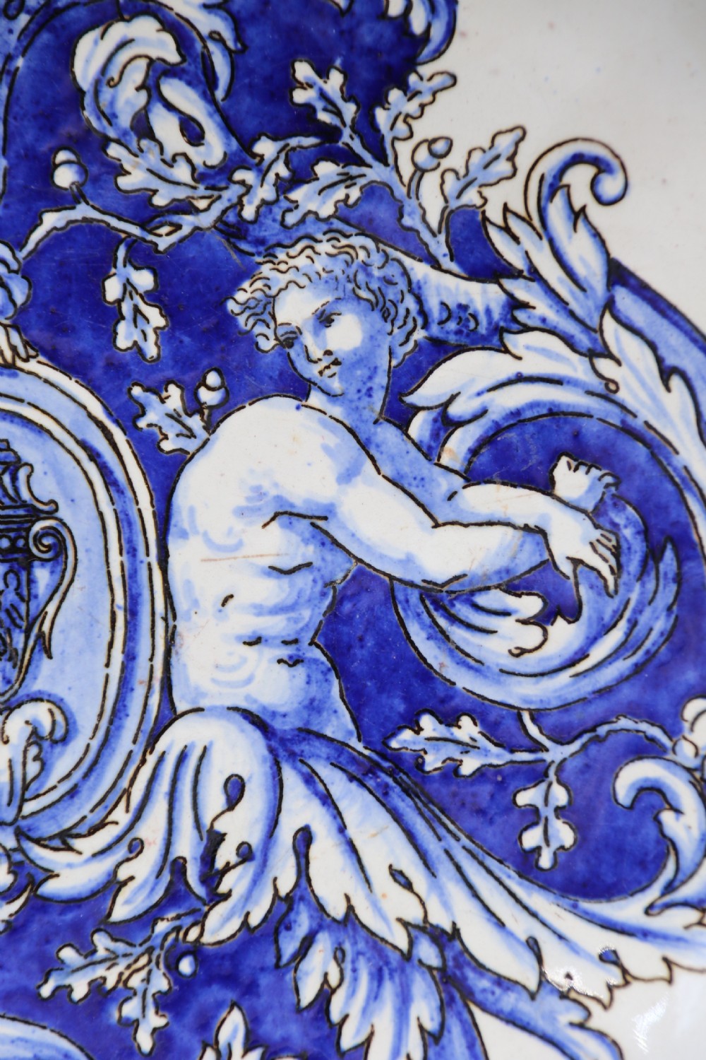 A hand-painted French Gien faience earthenware centrepiece dish with twin handles, decorated in cobalt blue and yellow mythological figures and acanthus scrollwork. View VII