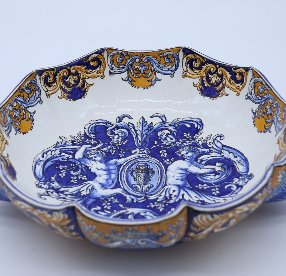 A hand-painted French Gien faience earthenware centrepiece dish with twin handles, decorated in cobalt blue and yellow mythological figures and acanthus scrollwork. View VIII