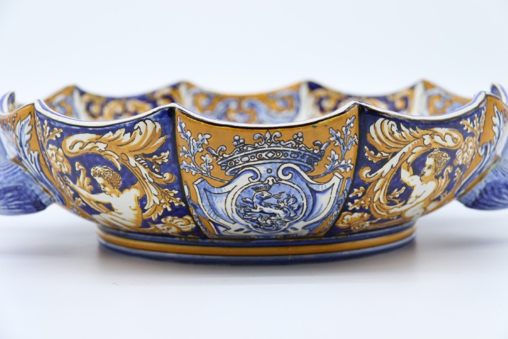 A hand-painted French Gien faience earthenware centrepiece dish with twin handles, decorated in cobalt blue and yellow mythological figures and acanthus scrollwork. View IX