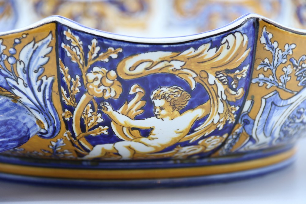 A hand-painted French Gien faience earthenware centrepiece dish with twin handles, decorated in cobalt blue and yellow mythological figures and acanthus scrollwork. View XII