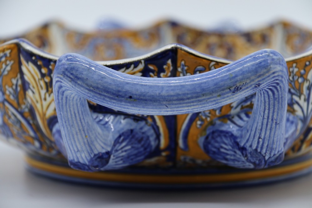 A hand-painted French Gien faience earthenware centrepiece dish with twin handles, decorated in cobalt blue and yellow mythological figures and acanthus scrollwork. View XIII
