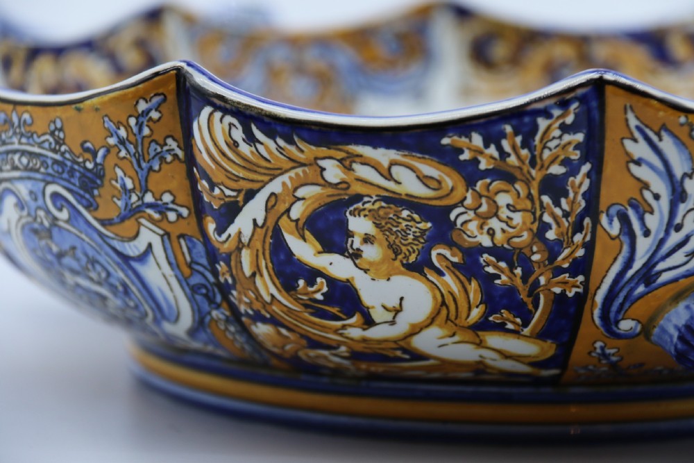 A hand-painted French Gien faience earthenware centrepiece dish with twin handles, decorated in cobalt blue and yellow mythological figures and acanthus scrollwork. View XIX