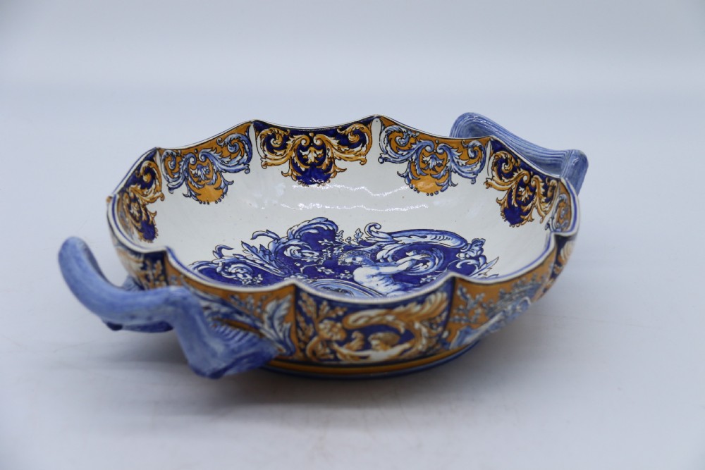 A hand-painted French Gien faience earthenware centrepiece dish with twin handles, decorated in cobalt blue and yellow mythological figures and acanthus scrollwork. View XXV