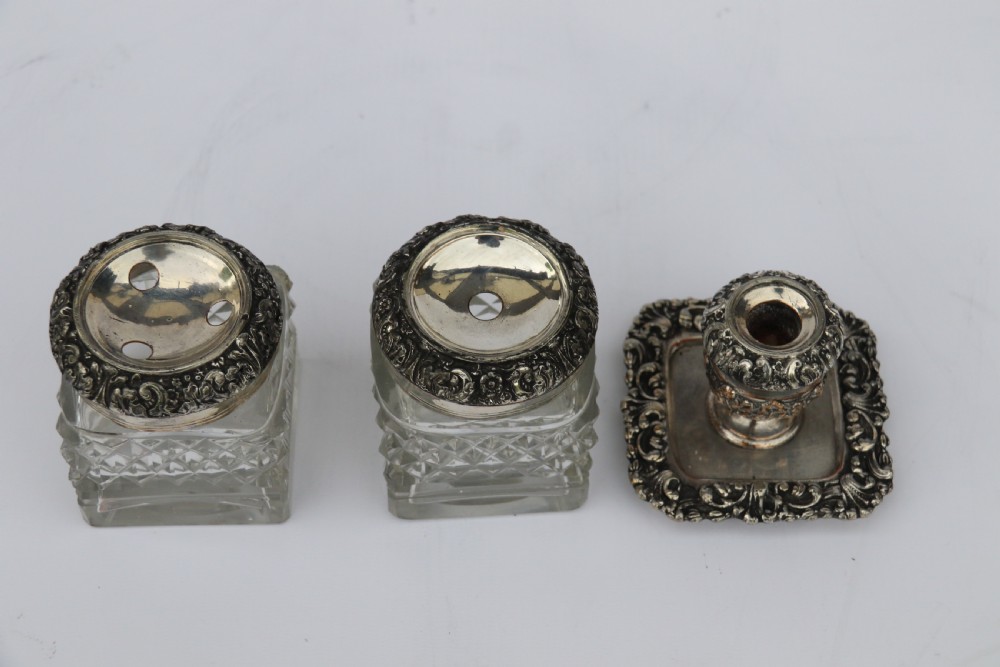 An early nineteenth-century Sheffield plate desk inkstand featuring two cut-glass inkwells and decorative scroll borders raised on paw feet. View XIII
