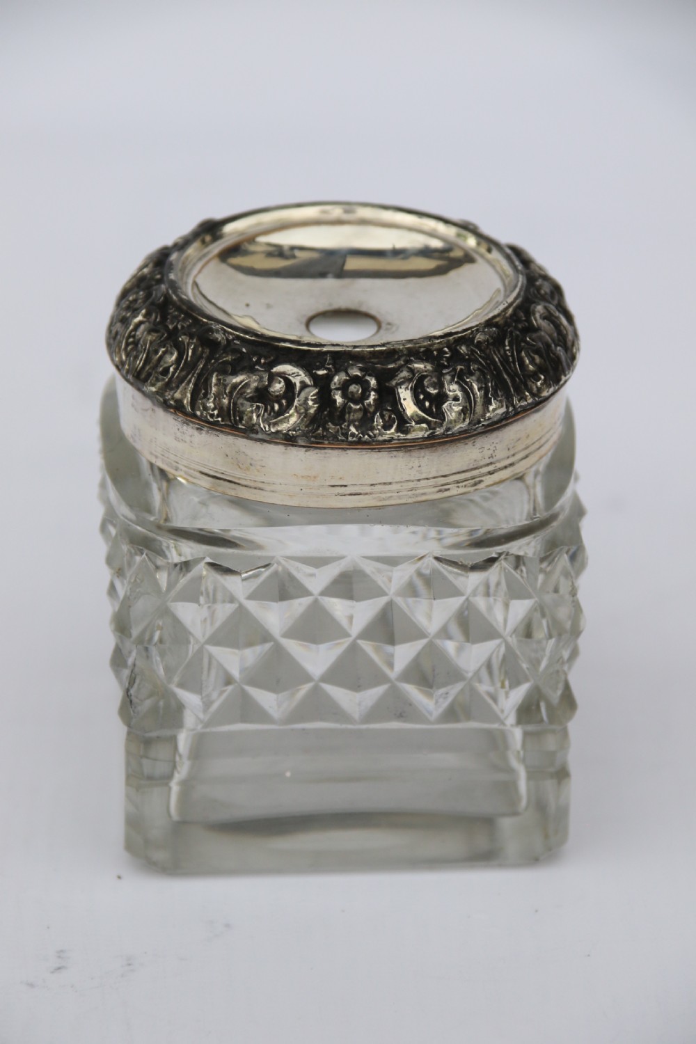 An early nineteenth-century Sheffield plate desk inkstand featuring two cut-glass inkwells and decorative scroll borders raised on paw feet. View XV