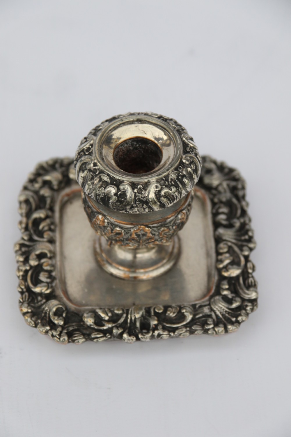 An early nineteenth-century Sheffield plate desk inkstand featuring two cut-glass inkwells and decorative scroll borders raised on paw feet. View XVI
