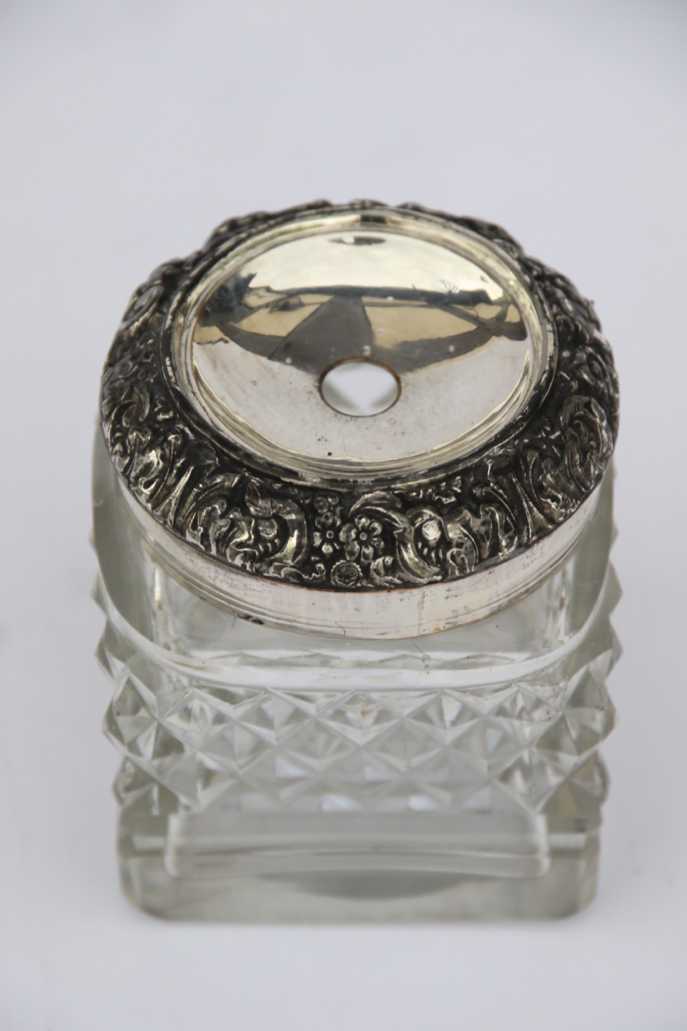 An early nineteenth-century Sheffield plate desk inkstand featuring two cut-glass inkwells and decorative scroll borders raised on paw feet. View XVII