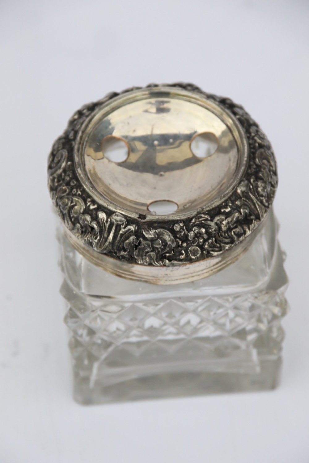 An early nineteenth-century Sheffield plate desk inkstand featuring two cut-glass inkwells and decorative scroll borders raised on paw feet. View XVIII