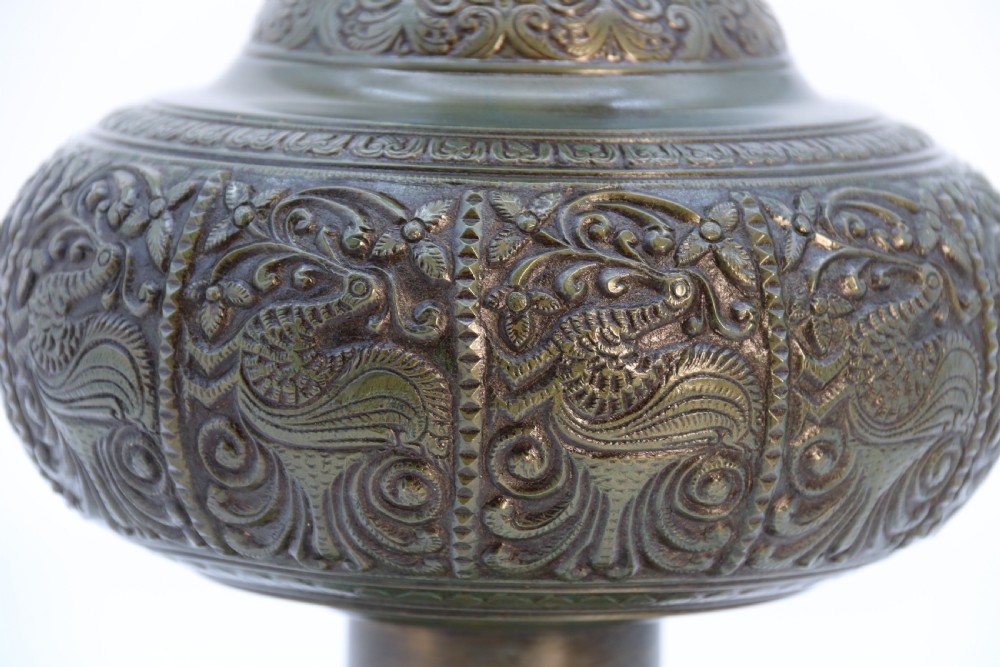 An antique nineteenth-century patinated bronze vase featuring hand-chased floral and foliate motifs, a bulbous center, flared neck, and circular base. View IV