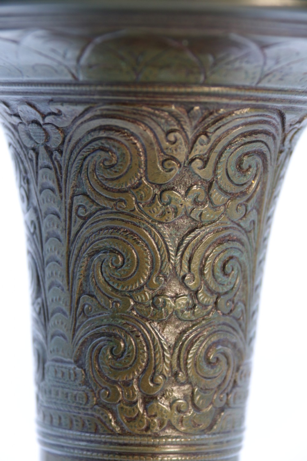 An antique nineteenth-century patinated bronze vase featuring hand-chased floral and foliate motifs, a bulbous center, flared neck, and circular base. View V