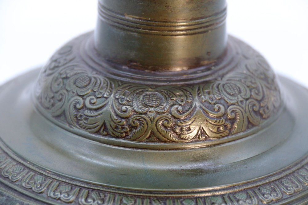An antique nineteenth-century patinated bronze vase featuring hand-chased floral and foliate motifs, a bulbous center, flared neck, and circular base. View VII