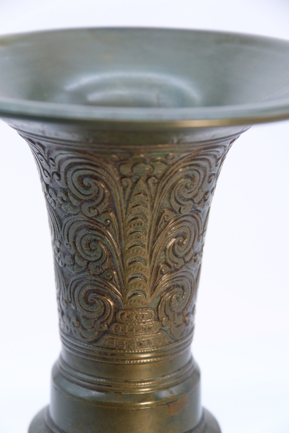 An antique nineteenth-century patinated bronze vase featuring hand-chased floral and foliate motifs, a bulbous center, flared neck, and circular base. View VIII