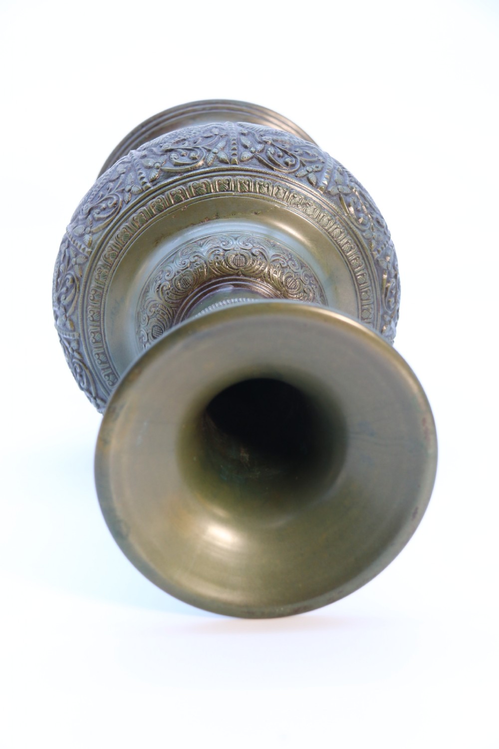 An antique nineteenth-century patinated bronze vase featuring hand-chased floral and foliate motifs, a bulbous center, flared neck, and circular base. View XI