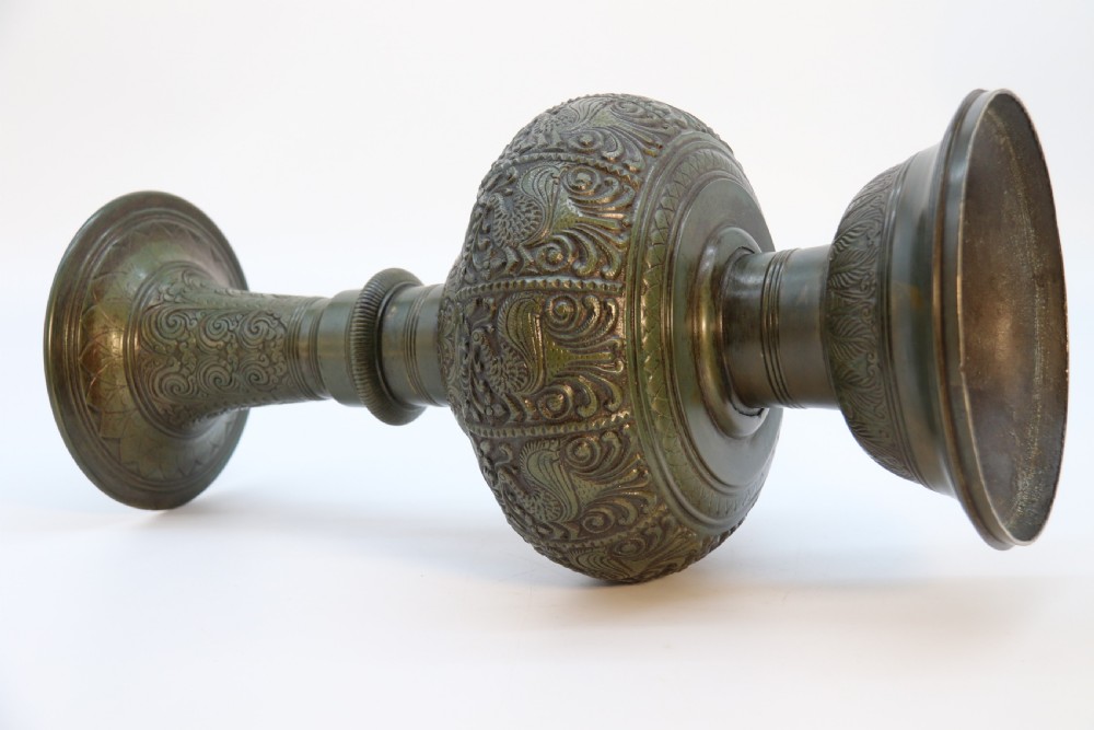 An antique nineteenth-century patinated bronze vase featuring hand-chased floral and foliate motifs, a bulbous center, flared neck, and circular base. View XIII
