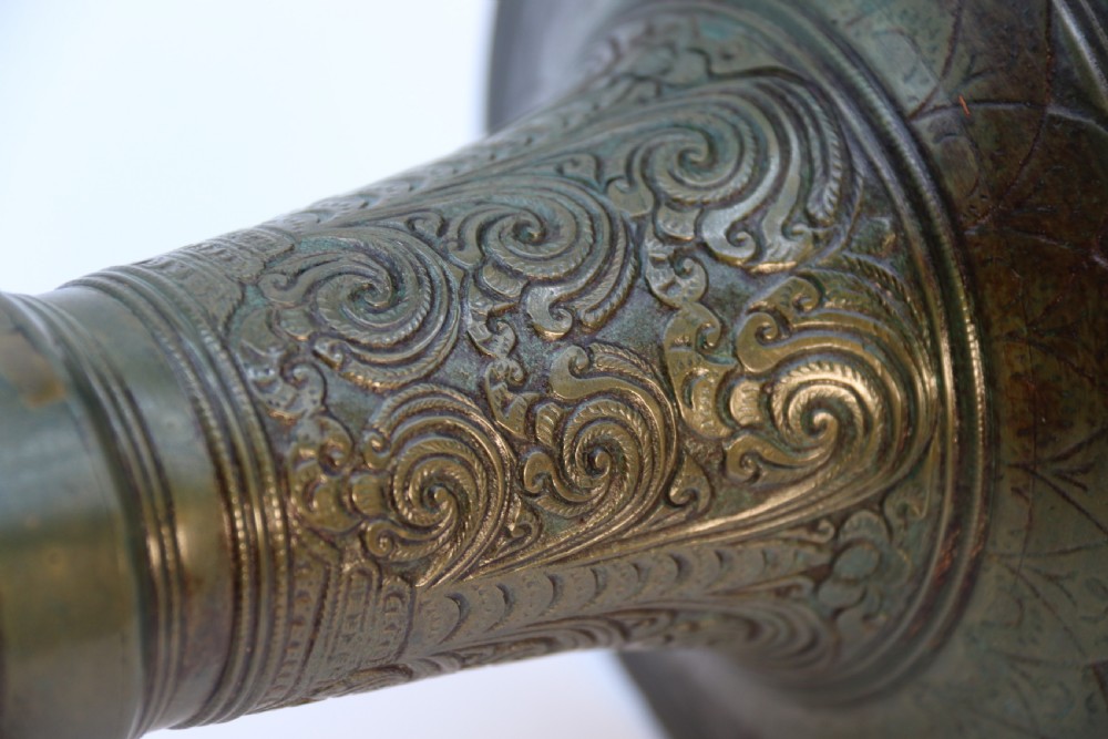 An antique nineteenth-century patinated bronze vase featuring hand-chased floral and foliate motifs, a bulbous center, flared neck, and circular base. View XIV