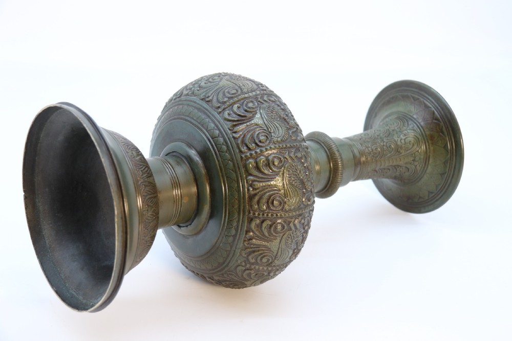An antique nineteenth-century patinated bronze vase featuring hand-chased floral and foliate motifs, a bulbous center, flared neck, and circular base. View XV