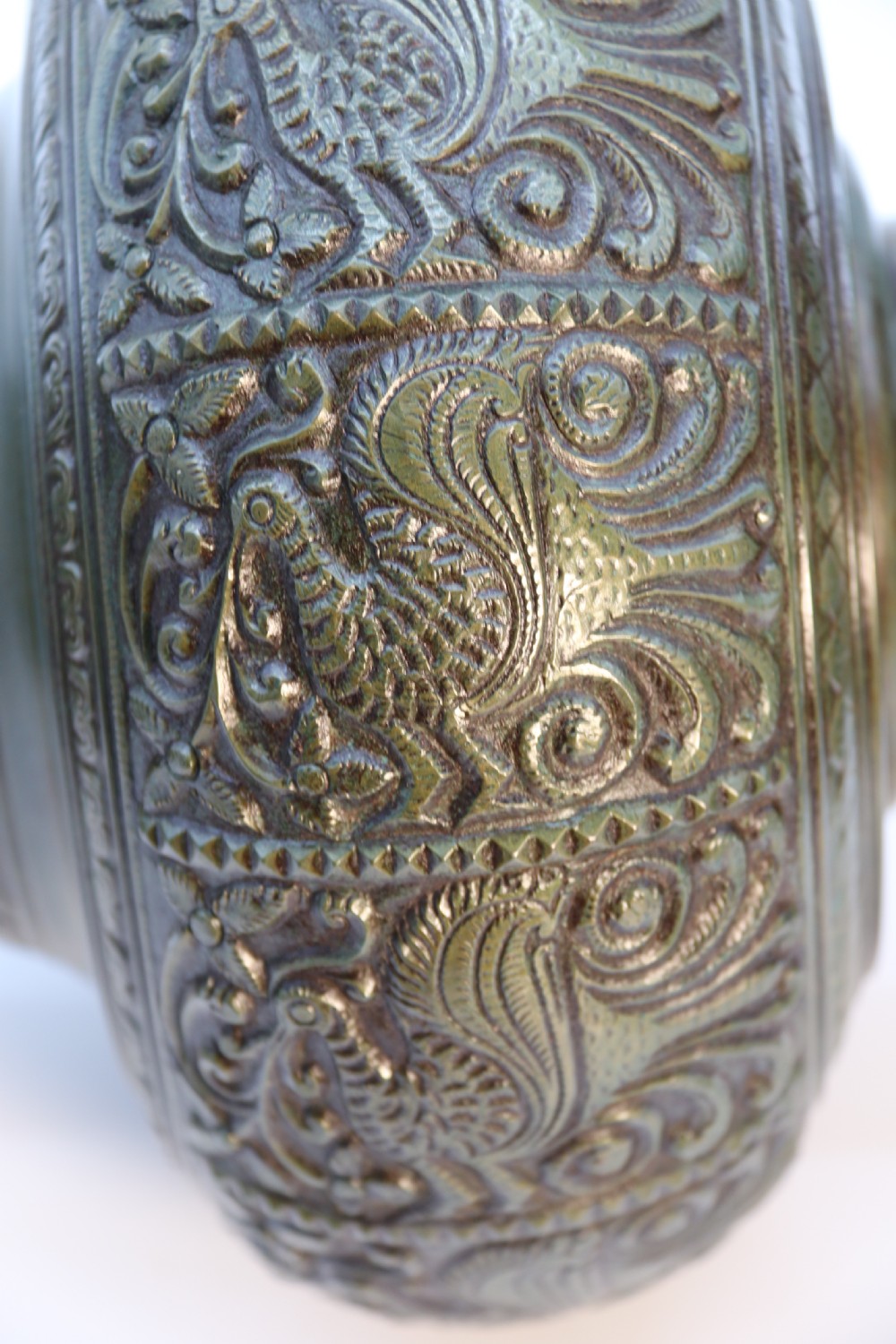 An antique nineteenth-century patinated bronze vase featuring hand-chased floral and foliate motifs, a bulbous center, flared neck, and circular base. View XVIII