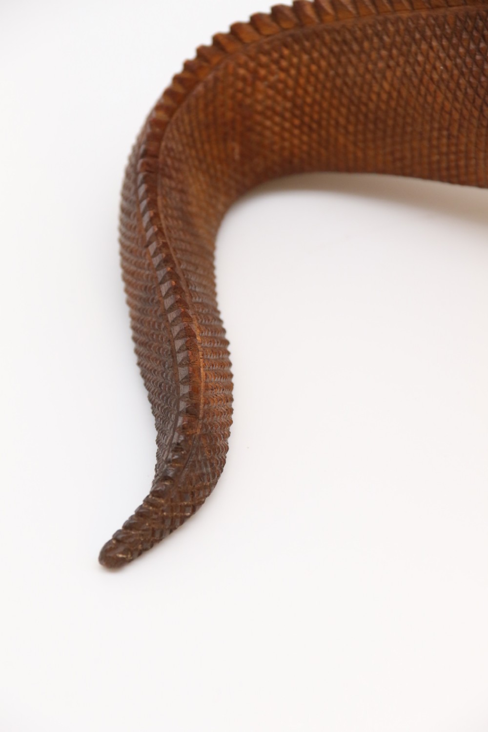 A hand-carved hardwood sculpture of an iguana featuring detailed scale patterns, a serrated dorsal crest, and a prominent dewlap in a warm brown finish. View XIII