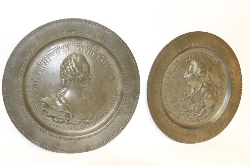 A pair of round silver grey pewter plates featuring raised profile relief portraits of Marie Antoinette and Louis XVI with beaded outer borders. View VII
